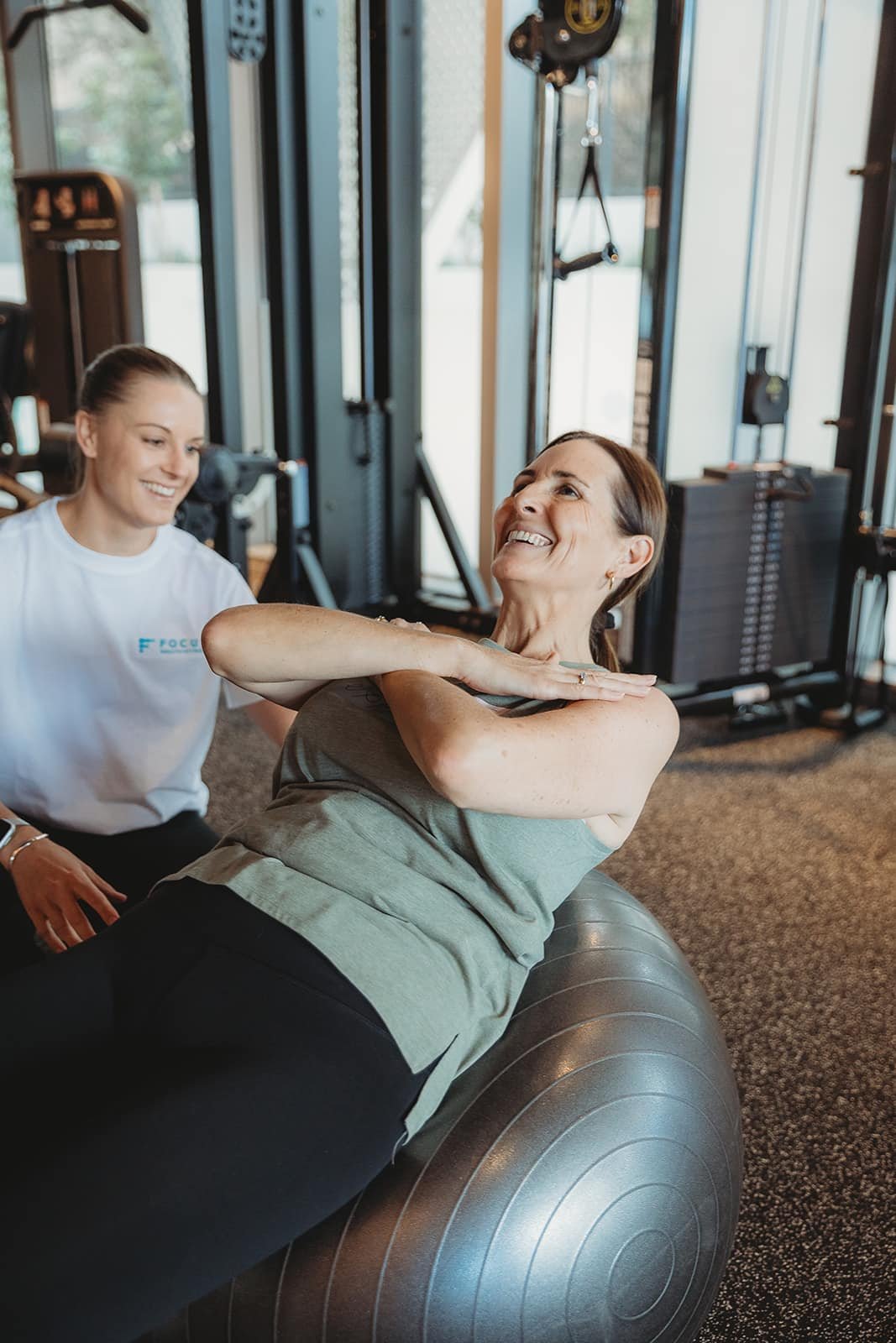Personal trainer coaching a client through a core strength exercise in a private Norwest gym