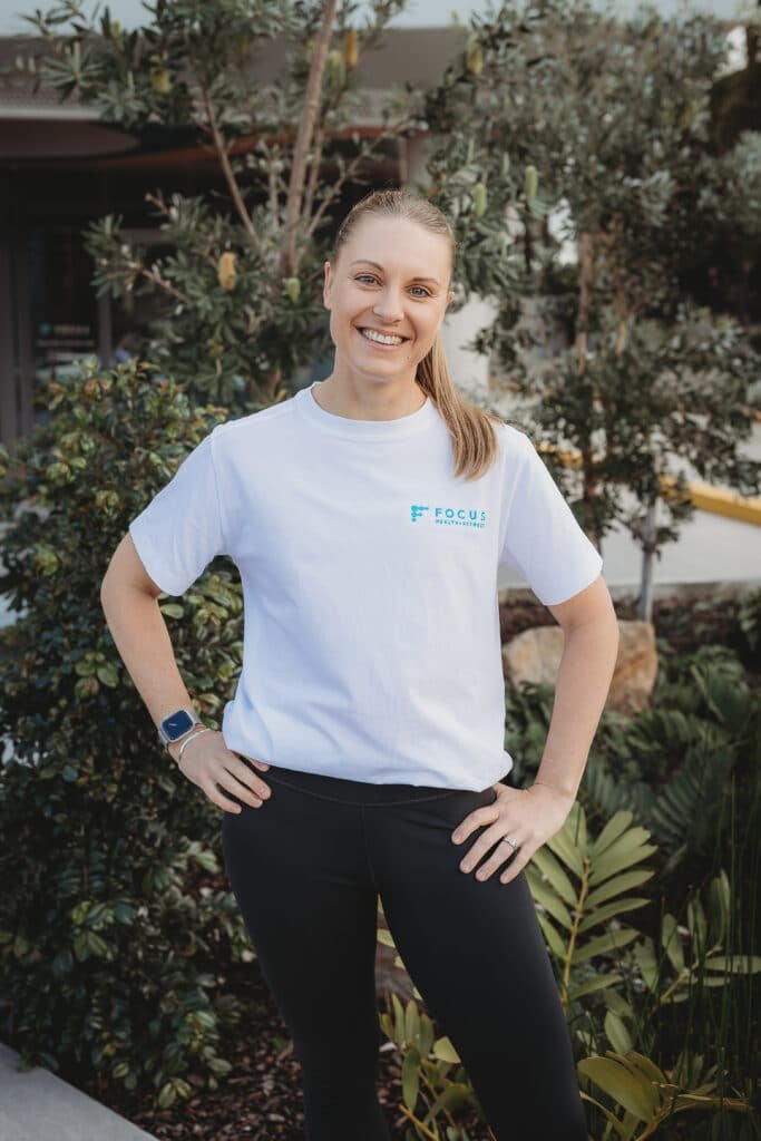 Maja Fraser, experienced personal trainer and holistic health coach at Focus Fit in Norwest, wearing focus health & fitness uniform