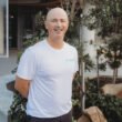 Ryan Fraser smiling in a white Focus Health & Fitness shirt, standing outside the Norwest personal training studio