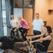 Personal trainers coaching clients on rowing machine and bike at Focus Health & Fitness Norwest, near Bella Vista, Castle Hill, Kellyville, and the Hills District.