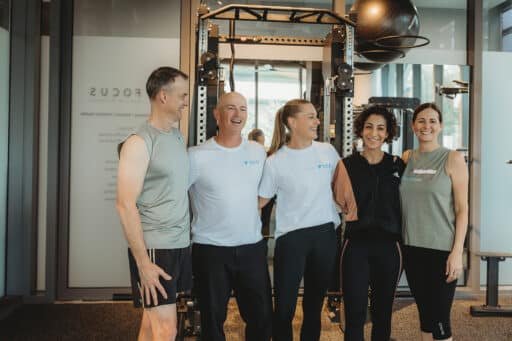 Personal trainers and happy clients in personal training session at Focus Health & Fitness Norwest, featuring clients improving strength and mobility with expert coaching