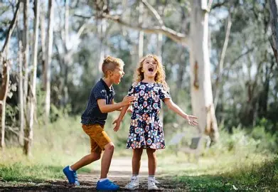Children playing at Castle Hill Heritage Park playground in the Hills District, a family-friendly park with trails and open spaces