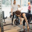 “Woman performing strength training with personal trainer in Norwest at Focus Health & Fitness studio for improved posture, fat loss and confidence.”