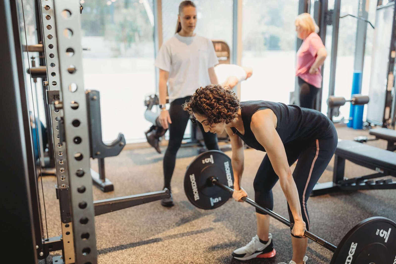 “Woman performing strength training with personal trainer in Norwest at Focus Health & Fitness studio for improved posture, fat loss and confidence.”