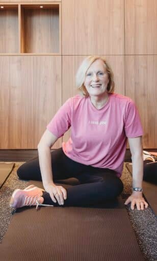 Adult with osteoporosis doing safe strength training with personal trainer in Norwest Hills District studio