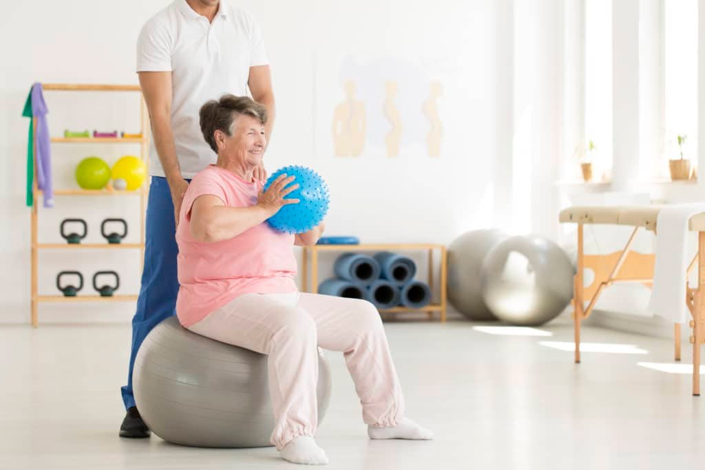 Adult with Parkinson's Disease Doing Supervised Exercise for Balance and Strength with Personal Trainer in Private Norwest Hills District Studio